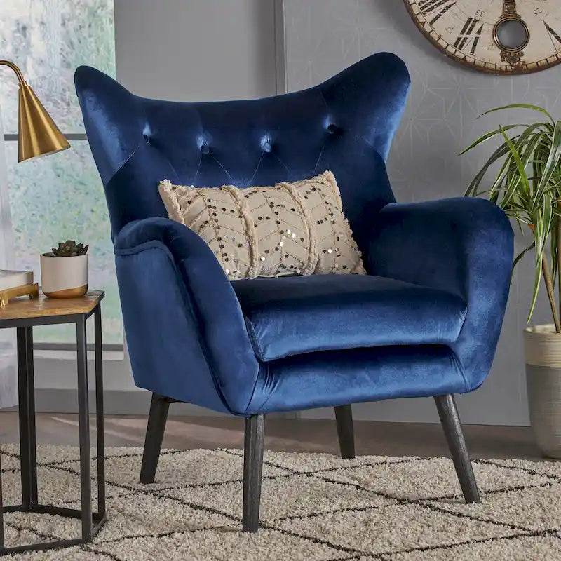Sillón auxiliar tapizado en terciopelo azul marino con orejeras