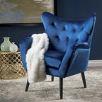 Sillón auxiliar tapizado en terciopelo azul marino con orejeras