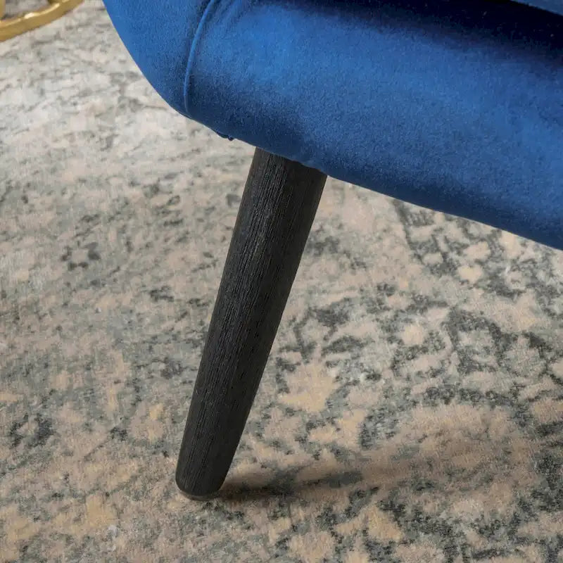 Sillón auxiliar tapizado en terciopelo azul marino con orejeras