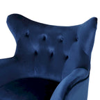 Sillón auxiliar tapizado en terciopelo azul marino con orejeras