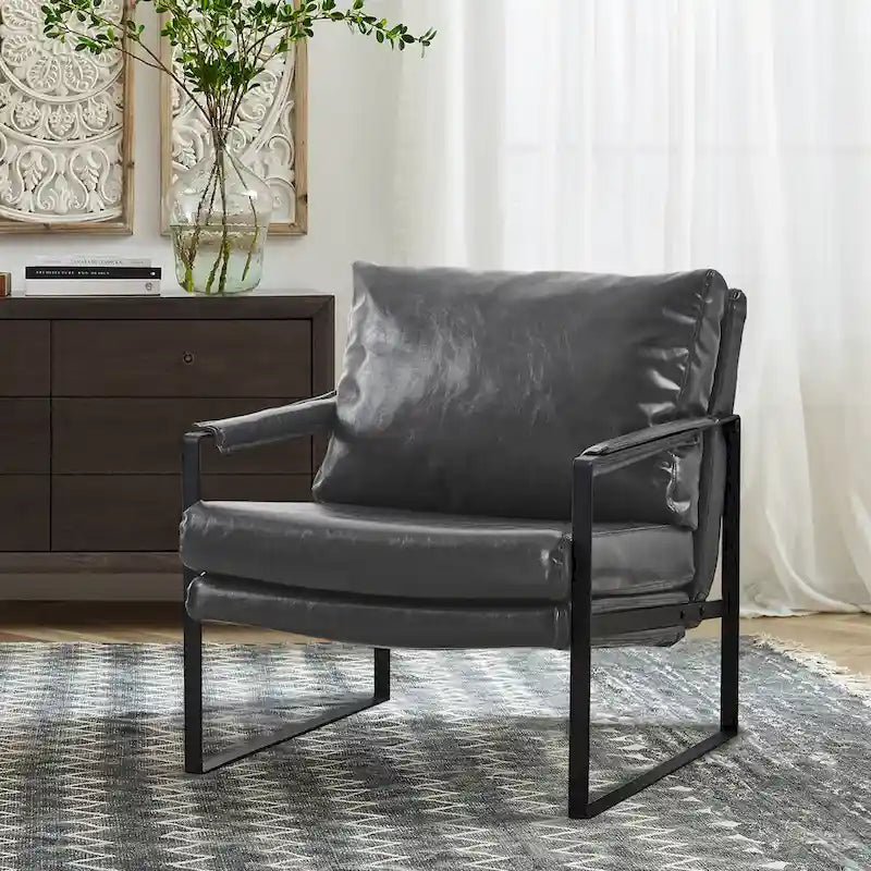 Sillón tapizado en piel sintética moderna con estructura de acero