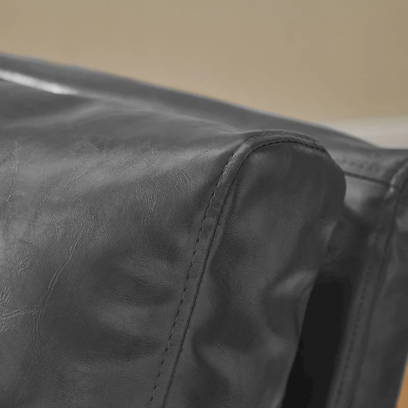 Sillón tapizado en piel sintética moderna con estructura de acero
