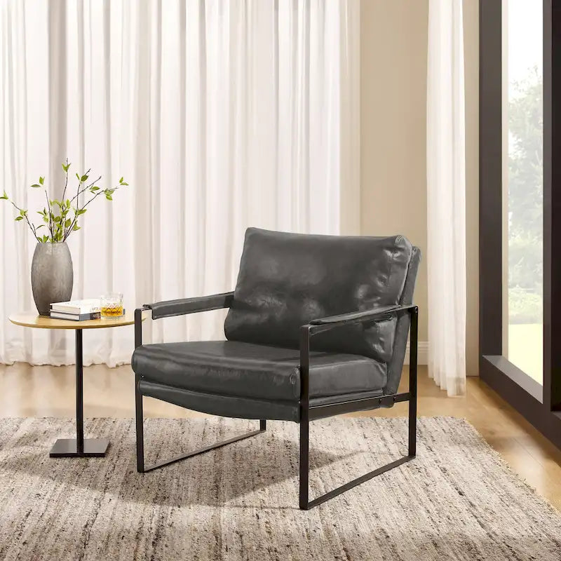 Sillón tapizado en piel sintética moderna con estructura de acero