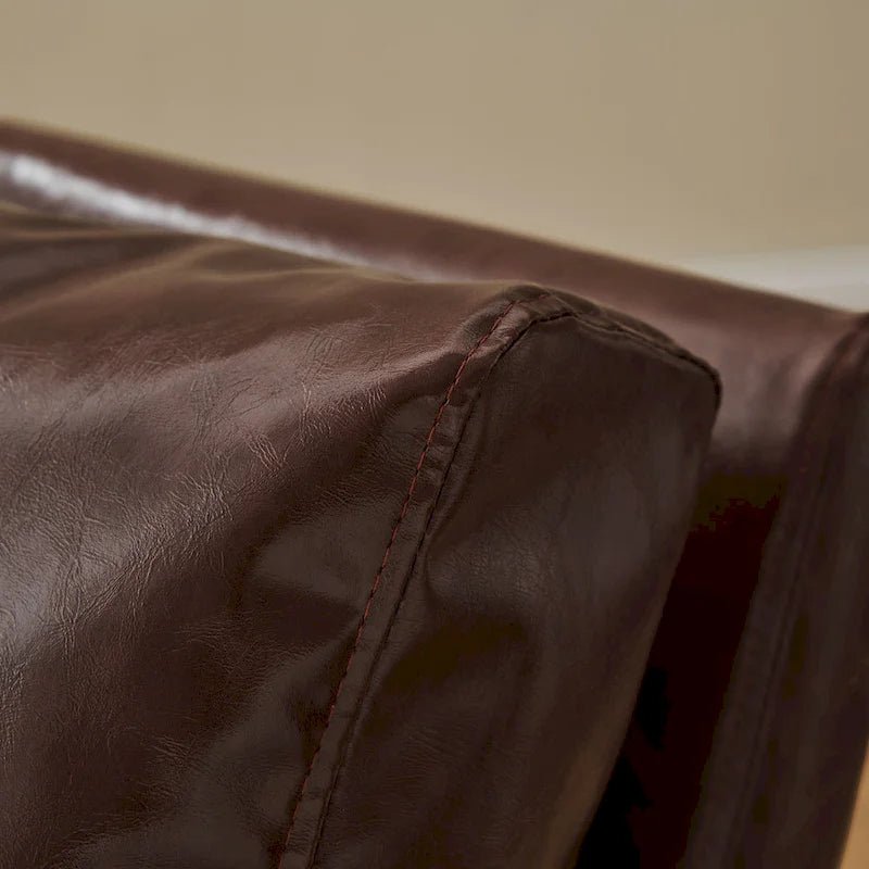 Sillón tapizado en piel sintética moderna con estructura de acero