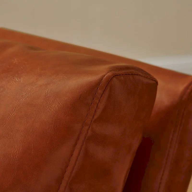Sillón tapizado en piel sintética moderna con estructura de acero